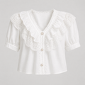White short-sleeve blouse with a large ruffled lace collar, puff sleeves, and decorative buttons on a light gray background.