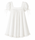 A white cotton gauze dress with puff sleeves, tie details on the sleeves, a square neckline, and a ruffled hem, shown against a plain white background.
