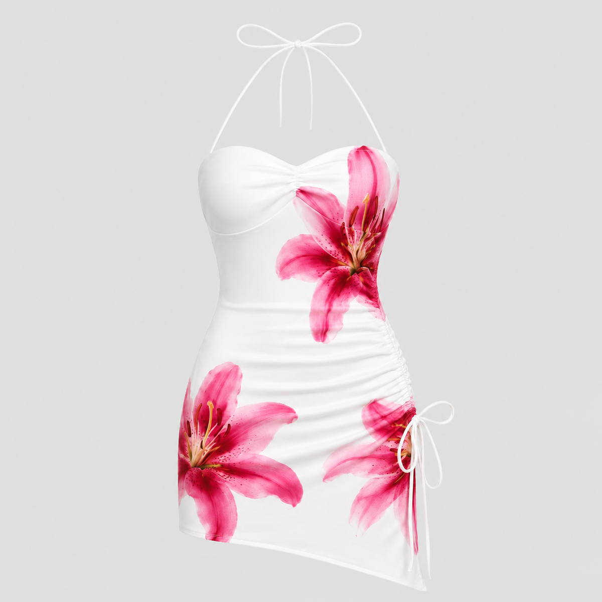 White halter mini dress with a sweetheart neckline, ruched bodice, and pink lily floral print, shown on a light gray background.