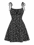 A black sleeveless mini dress with a white ditsy floral print, featuring thin shoulder ties and a flared skirt, shown against a plain white background.