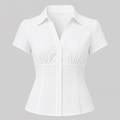 A white short-sleeve button-up blouse with a textured crinkle fabric, featuring a pointed collar, button front, and gathered waist details, shown on a neutral gray background.
