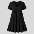 A black short-sleeve V-neck dress with a gathered waist and a flared ruffled hem, shown against a solid light gray background.