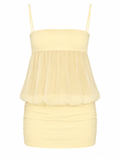A pale yellow spaghetti-strap mini dress featuring a structured sweetheart bodice, a sheer mesh peplum overlay, and a ruched gathered skirt, shown against a plain white background.