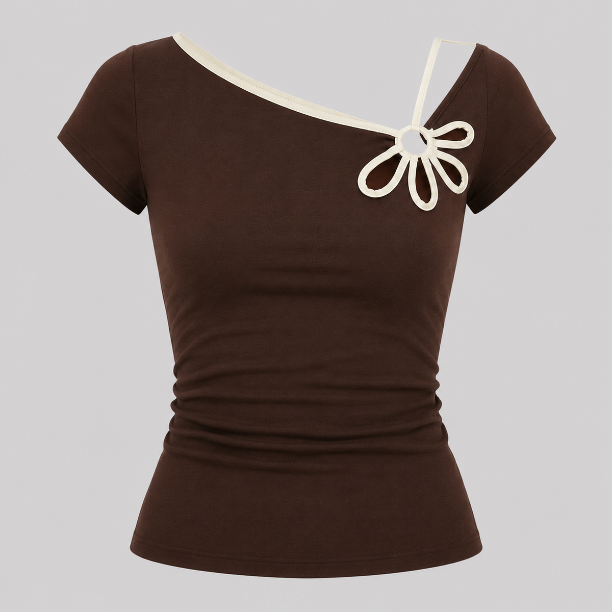 A dark brown short-sleeve top with an asymmetrical cream-colored neckline and a decorative cream bow detail on the chest, displayed on a neutral gray background.